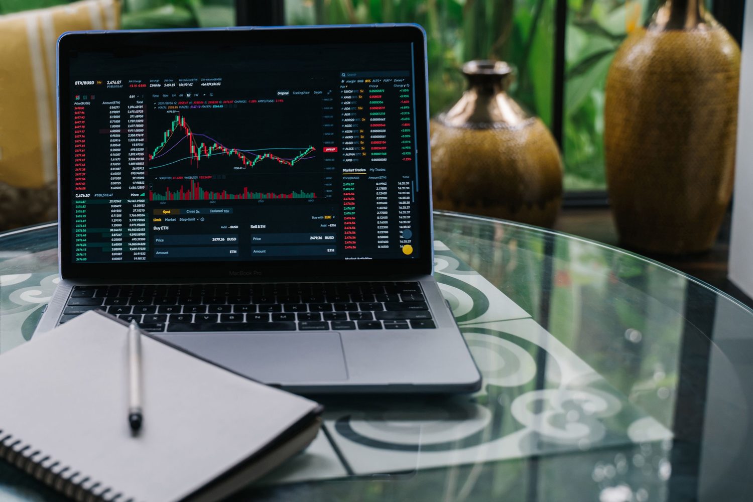 A laptop displaying cryptocurrency market charts